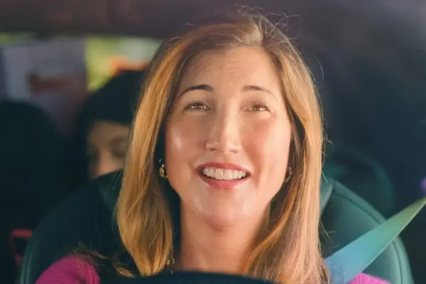 Jackie Sandler as Gabi in You Are So Not Invited to My Bat Mitzvah, driving a car and smiling