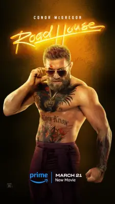 Conor McGregor poses topless with his hands on his sunglasses as Knox for Road House.