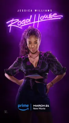 Jessica Williams poses with her hands on her hips and smiling in a dress and smiling as Frankie for Road House.