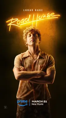 Lukas Gage in a short-sleeved shirt poses as Billy for a Road House poster.