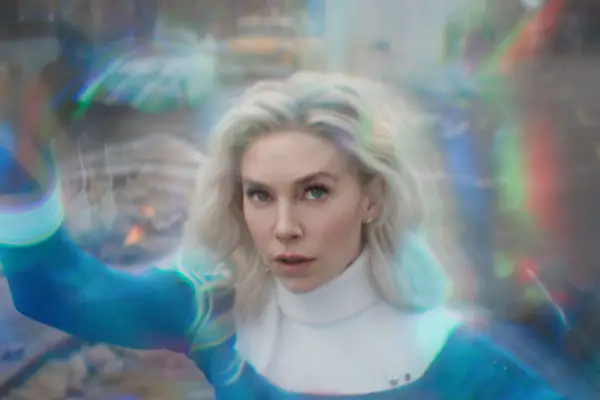 Vanessa Kirby in her blue and white costume as Susan Storm in close-up behind a force-field for The Fantastic Four: First Steps.