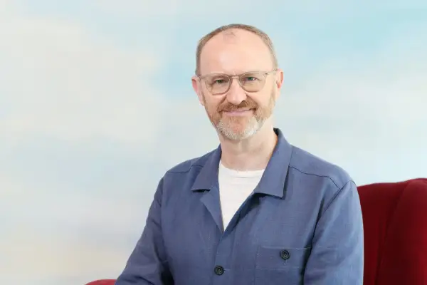 Mark Gatiss in a blue shirt smiling