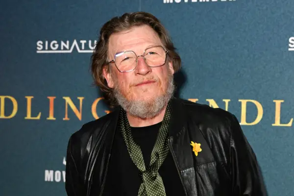 Geoff Bell in a leather jacket wearing a greenn spotty tie