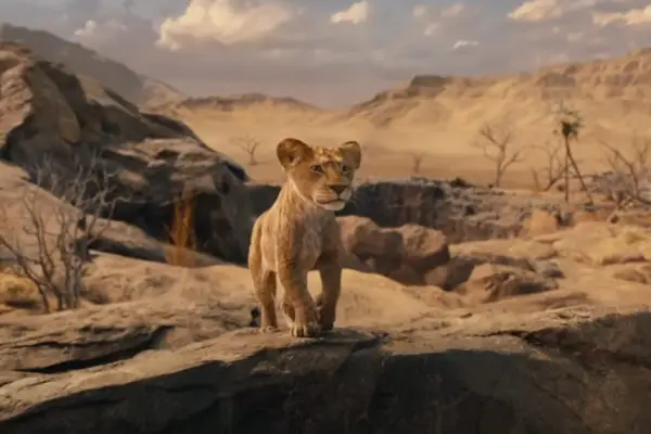 Mufasa The Lion King still showing a young Mufasa on a rock
