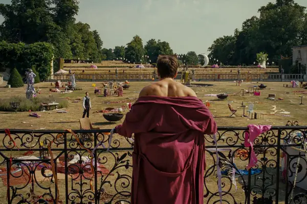A character wearing a red robe overlooking grand gardens