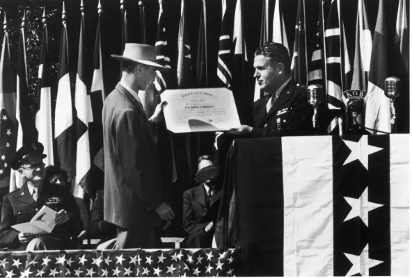 Army-Navy Award of excellence presented by General L. R. Groves to Director Robert Oppenheimer, circa 1940s.