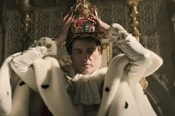 Joaquin Phoenix as Napoleon Bonaparte crowning himself Emperor in Apple TV+ film Napoleon.