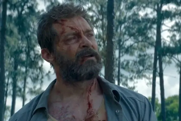 Hugh Jackman as Wolverine in Logan, with cuts on his face and neck
