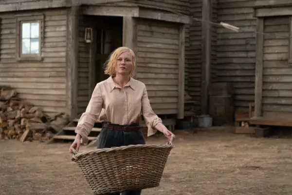 KIRSTEN DUNST as ROSE GORDON in THE POWER OF THE DOG holding a large basket