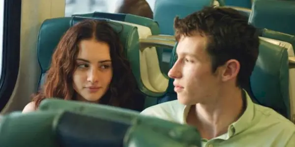 A couple sitting next to each other on a train