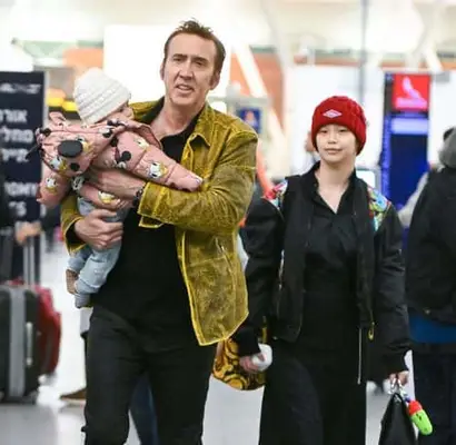 The little one looked adorable in a pink Disney puffer jacket, blue jeans, striped socks and a cozy white beanie (Backgrid)