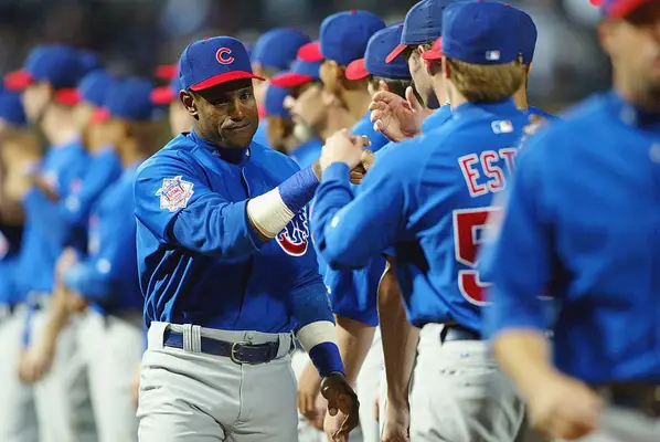 Sammy Sosa #21 of the Chicago Cubs greets teammates during player introductions prior to Game 1 of the National League Division Series between the Chicago Cubs and the Atlanta Braves on September 30, 2003 at Turner Field in Atlanta, Georgia. The Cubs defeated the Braves 4-2. (Photo by Jamie Squire/Getty Images) 