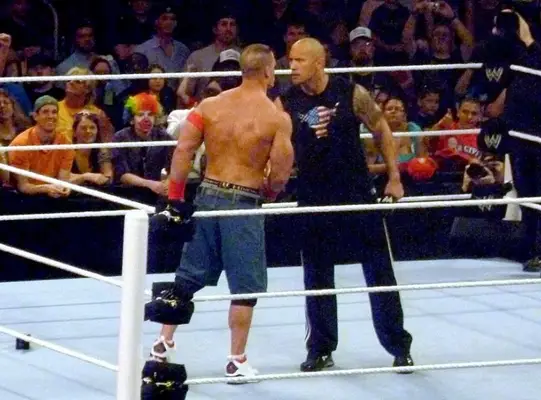 Dwayne Johnson and John Cena during a Wrestlemania Match (Wikipedia)