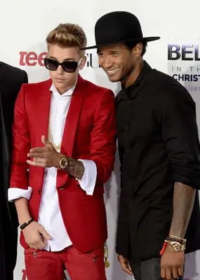 Justin Bieber and Usher standing side by side (Photo by Jason Kempin/Getty Images)