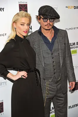 Actors Amber Heard (L) and Johnny Depp attend the 