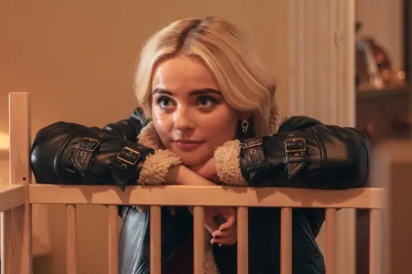 Millie Gibson as Ruby Sunday in Doctor Who leaning on a wooden cot