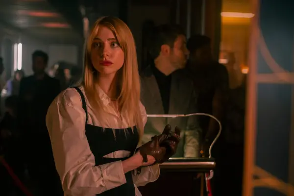 Maddie Phillips as Cate Dunlap in Gen V wearing a white shirt and leather gloves