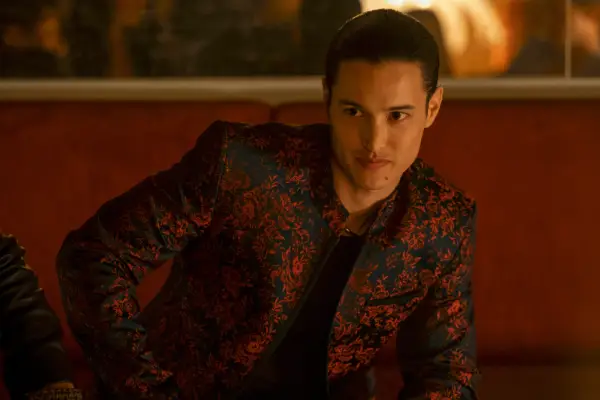 Derek Luh as Jordan in Gen V wearing a black and red flowery jacket