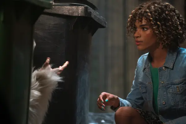 Yasmin Finney in Doctor Who: The Star Beast looking at a creature between two bins