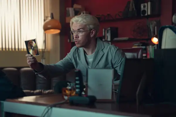 Will Poulter in Black Mirror sat holding a CD
