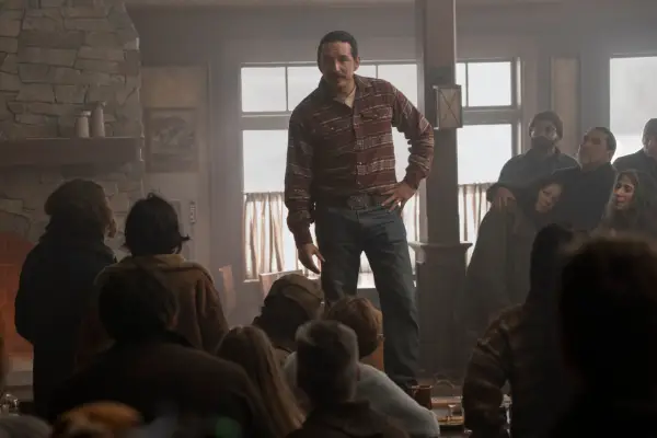 Gabriel Luna as Tommy in The Last of Us season 2 standing in front of a crowd of people, giving a speech.
