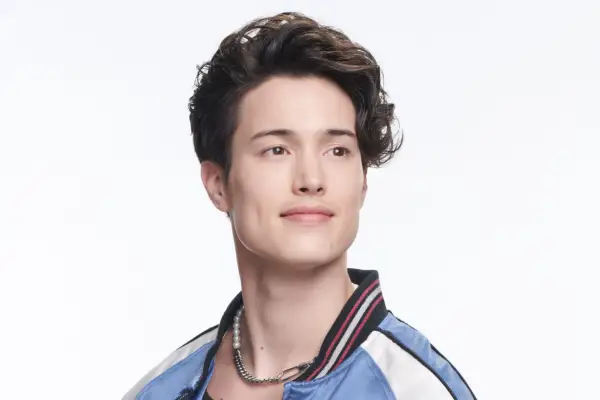 Derek Luh as Jordan Li in Gen V wearing a blue and white jacket