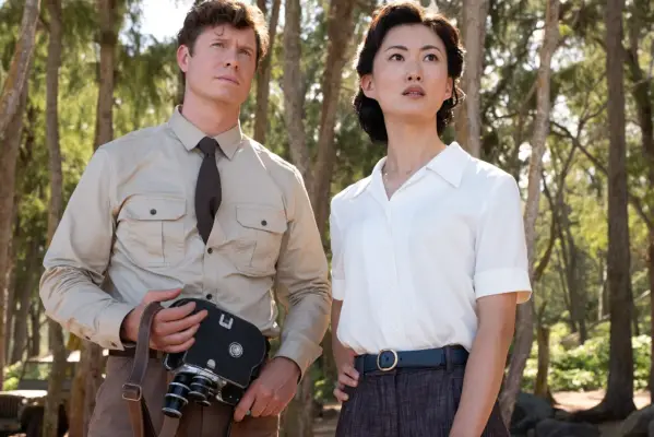 Anna Sawai as Cate Randa in Monarch: Legacy of Monsters looking up in the rain.