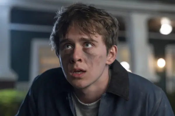 Sam McCarthy as Devin in Goosebumps: The Vanishing looking scared as he stares at something with black dust covering his face.