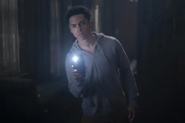 Zack Morris as Isaiah in Goosebumps holding up his phone which has the torch on.