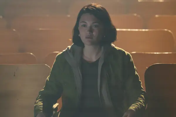 Isa Briones as Margot in Goosebumps sitting in a hall.