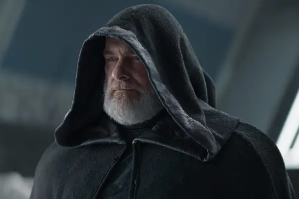 Ray Stevenson as Baylan Skoll in Ahsoka, wearing a robe with his hood up