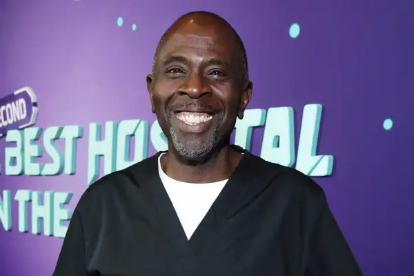 Gary Anthony Williams wears a black jersey with a white t-shirt underneath at The Second Best Hospital in the Galaxy premiere