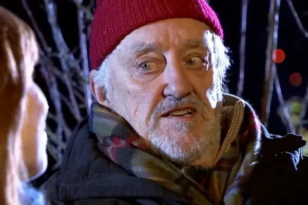 Bernard Cribbins as Wilfred Mott in Doctor Who wearing a red hat and scarf