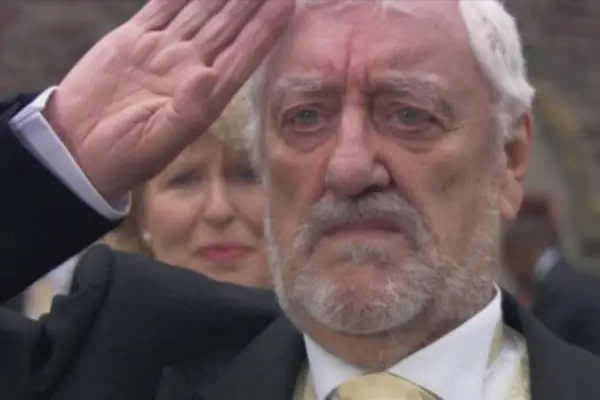 Bernard Cribbins as Wilfred Mott in Doctor Who wearing a suit, saluting
