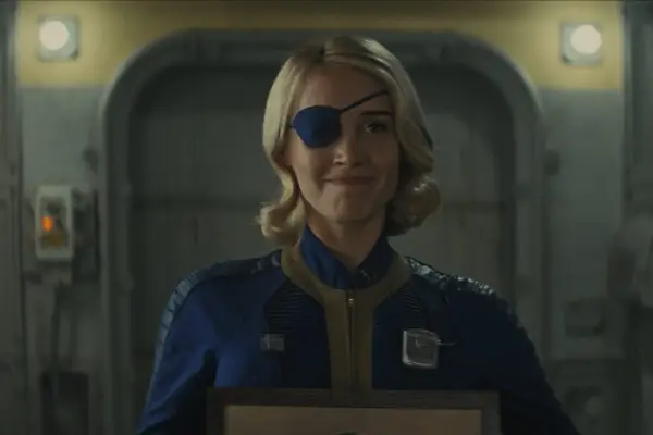 Annabel O’Hagan as Steph in Fallout in blue and yellow overalls with a blue eye patch