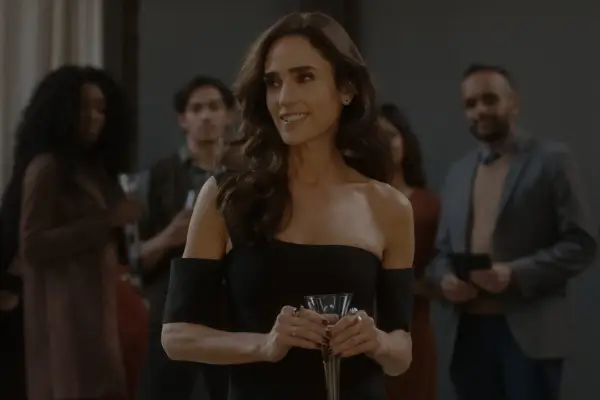 Jennifer Connelly in Dark Matter holding a glass of wine at an event