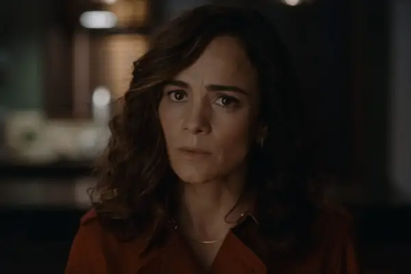 Dayo Okeniyi in Dark Matter, wearing a red shirt