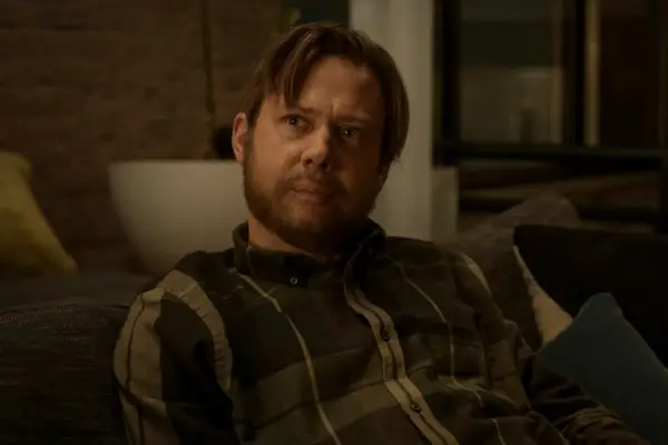 Jimmi Simpson in Dark Matter in a chequered shirt looking serious