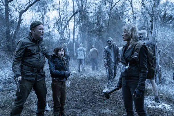 Rubén Blades as Daniel Salazar, Antonella Rose as Tracy and Kim Dickens as Madison Clark in Fear the Walking Dead standing in a forest, with zombies in the background