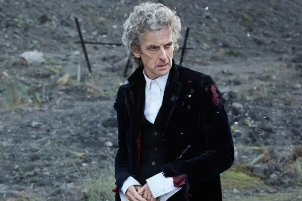 Peter Capaldi wearing a tattered suit