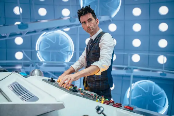 The Doctor (David Tennant) in Doctor Who standing in the TARDIS using the control panel