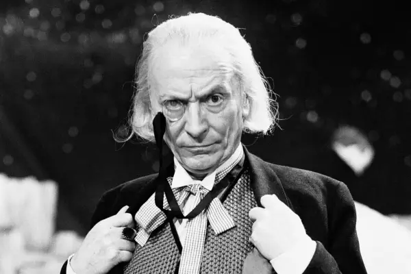 William Hartnell during rehearsals for Doctor Who wearing a monocle and a suit