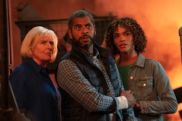 Jacqueline King, Karl Collins and Yasmin Finney in Doctor Who standing together looking concerned