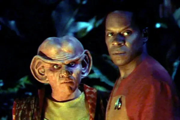 Armin Shimerman as Quark and Avery Brooks as Commander Benjamin Sisko in Star Trek: Deep Space Nine standing next to each other looking angry