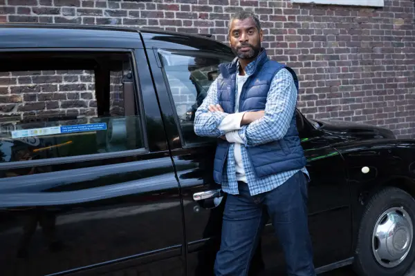 Shaun Temple (Karl Collins) in Doctor Who leaning on a taxi