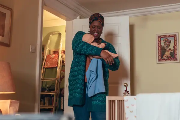 Michelle Greenidge as Carla Sunday in Doctor Who holding a baby