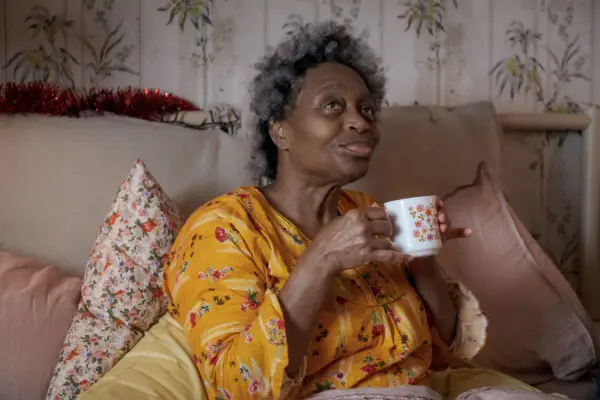 Cherry (Angela Wynter) in Doctor Who sitting with a cup of tea