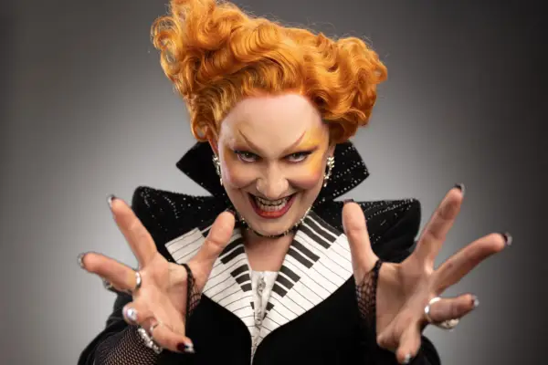 Jinkx Monsoon for Doctor Who season 14, wearing a suit with piano keys on it, looking menacing