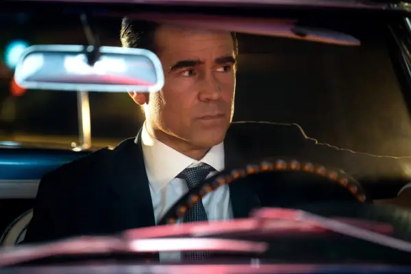 Colin Farrell as John Sugar in Sugar wearing a suit, sitting behind the wheel of a car
