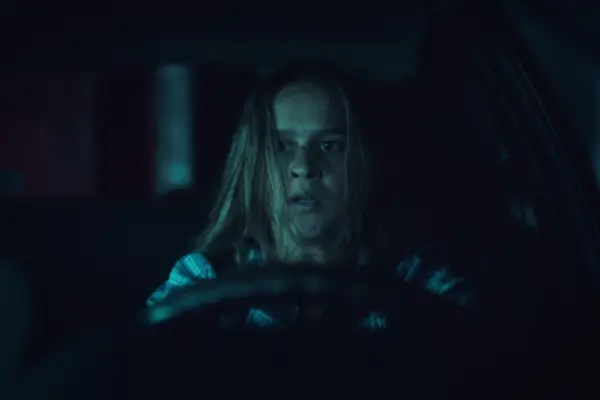 Clara Rugaard sitting behind the wheel of a car